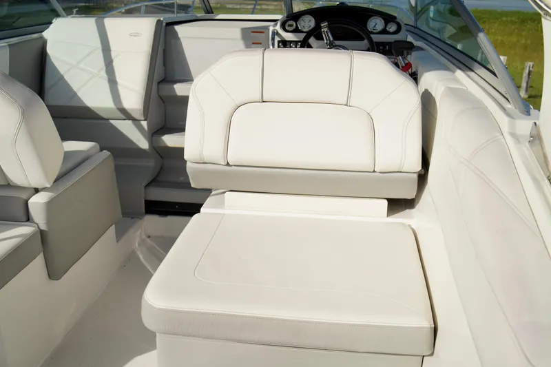 Slide: The Image of 2019 Regal 26 Express boat interior with white leather seating and dashboard view. - 14