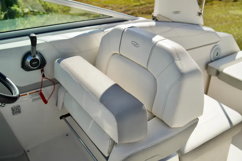 Slide: The Image of 2019 Regal 26 Express boat interior with white leather seating and control panel. - 15