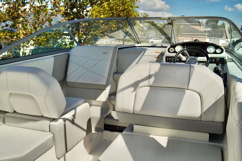 Slide: The Image of 2019 Regal 26 Express boat interior with white seating and modern dashboard. - 16