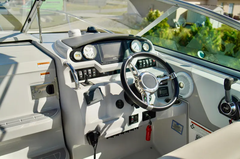 Slide: The Image of 2019 Regal 26 Express boat cockpit with steering wheel and control panel. - 17