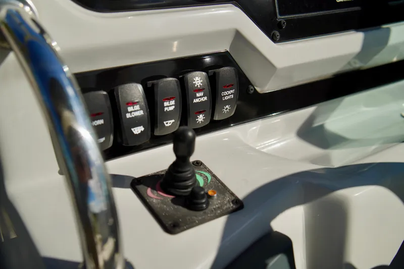 Slide: The Image of Control panel of a 2019 Regal 26 Express boat with switches and joystick. - 23