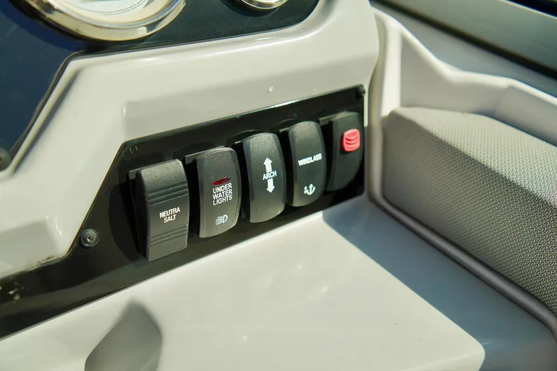 Slide: The Image of Control panel of a 2019 Regal 26 Express boat with various switches. - 24