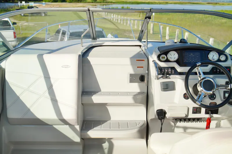 Slide: The Image of 2019 Regal 26 Express boat cockpit with steering wheel and dashboard controls. - 26