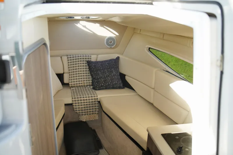 Slide: The Image of Interior of 2019 Regal 26 Express boat with cozy seating and cushions. - 27