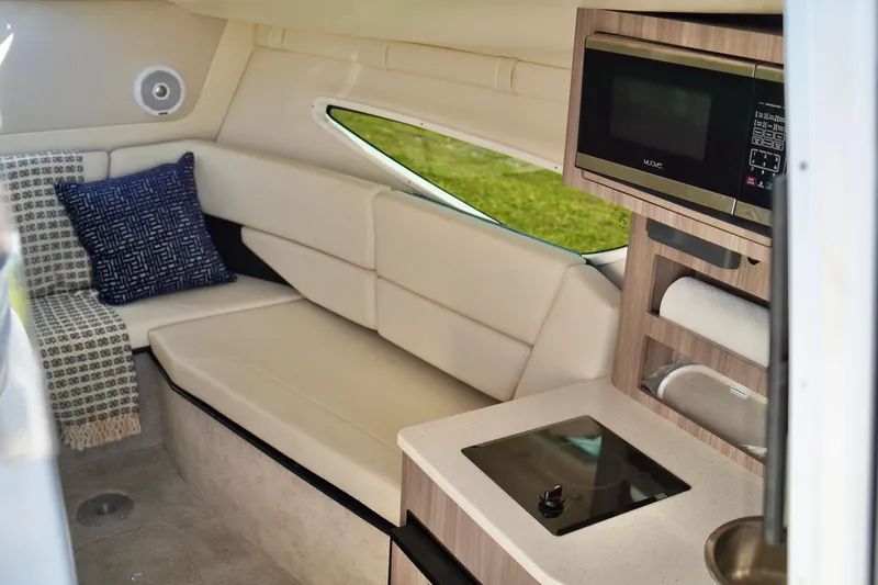 Slide: The Image of Interior of 2019 Regal 26 Express boat with kitchenette and seating area. - 28