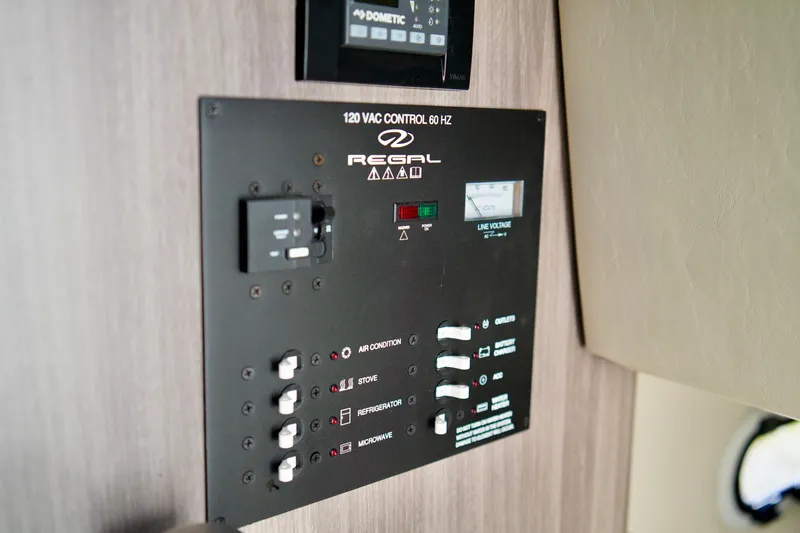 Slide: The Image of Control panel of a 2019 Regal 26 Express boat, featuring various switches and indicators. - 34