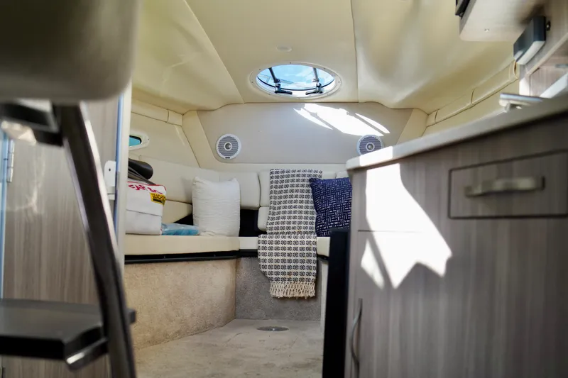 Slide: The Image of Interior of 2019 Regal 26 Express boat, featuring cozy seating and modern design. - 35