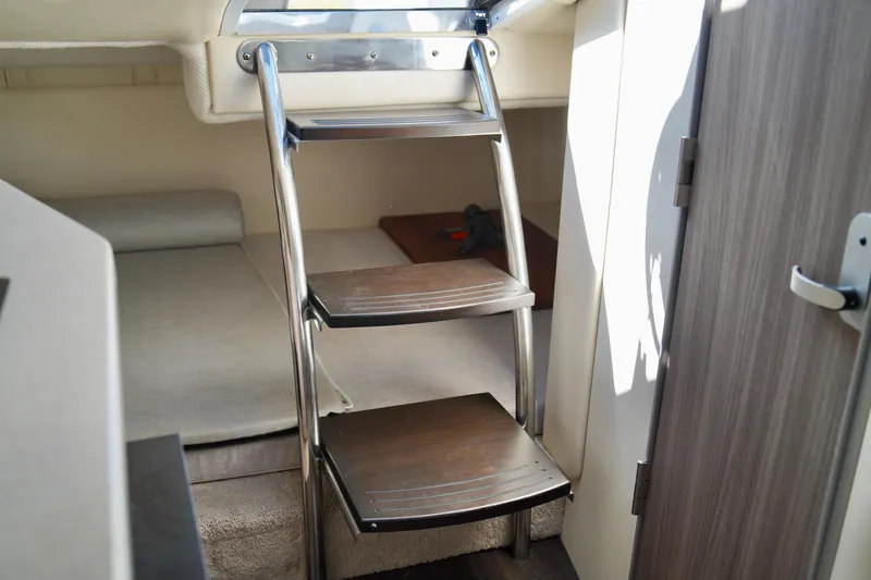 Slide: The Image of Interior of 2019 Regal 26 Express boat with compact cabin and wooden steps. - 37