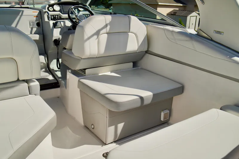 Slide: The Image of 2019 Regal 26 Express boat interior with white seating and modern dashboard. - 47