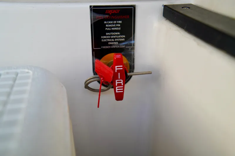 Slide: The Image of Fire extinguisher pull handle on 2019 Regal 26 Express boat. - 50