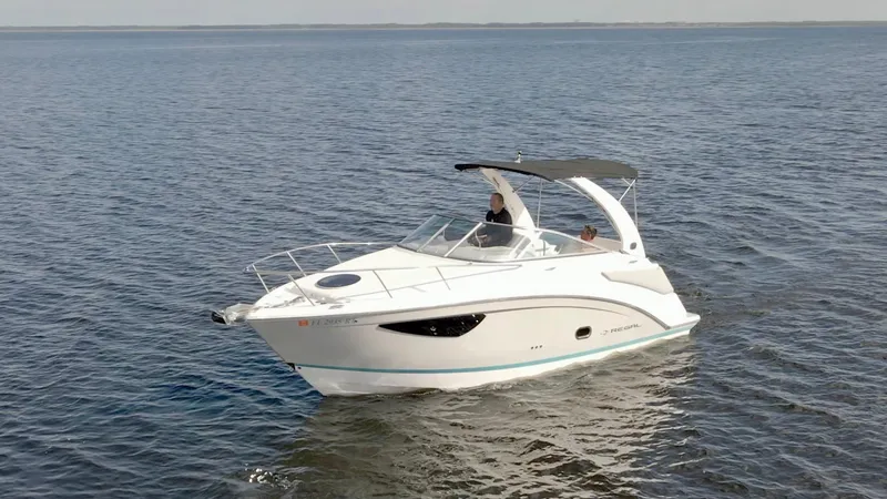 Slide: The Image of 2019 Regal 26 Express boat cruising on open water. - 53