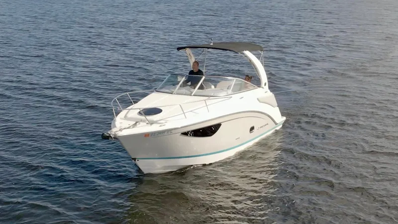 Slide: The Image of 2019 Regal 26 Express boat cruising on open water. - 54