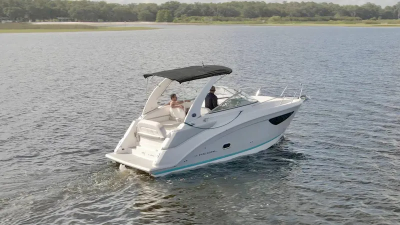 Slide: The Image of 2019 Regal 26 Express boat cruising on a serene lake. - 56
