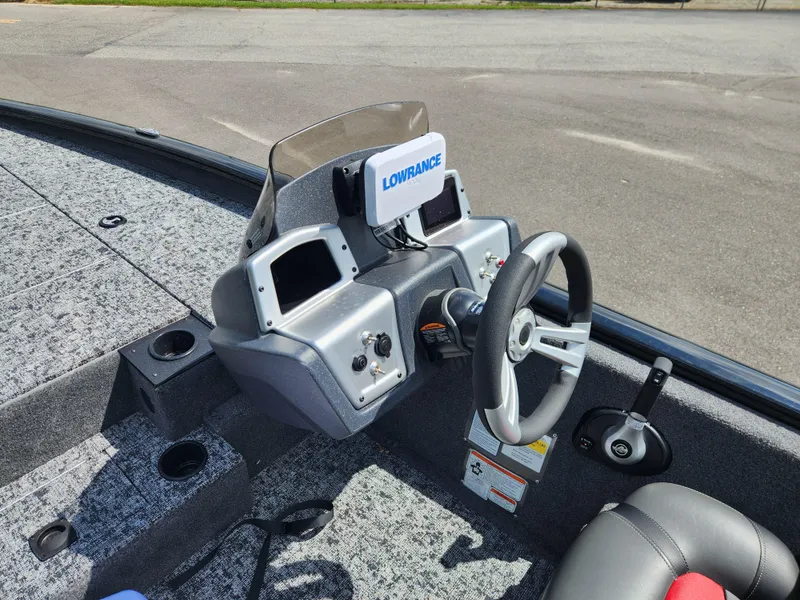 Slide: The Image of 2025 Tracker Pro Team 195 Tournament Edition boat dashboard with steering wheel and navigation system. - 11