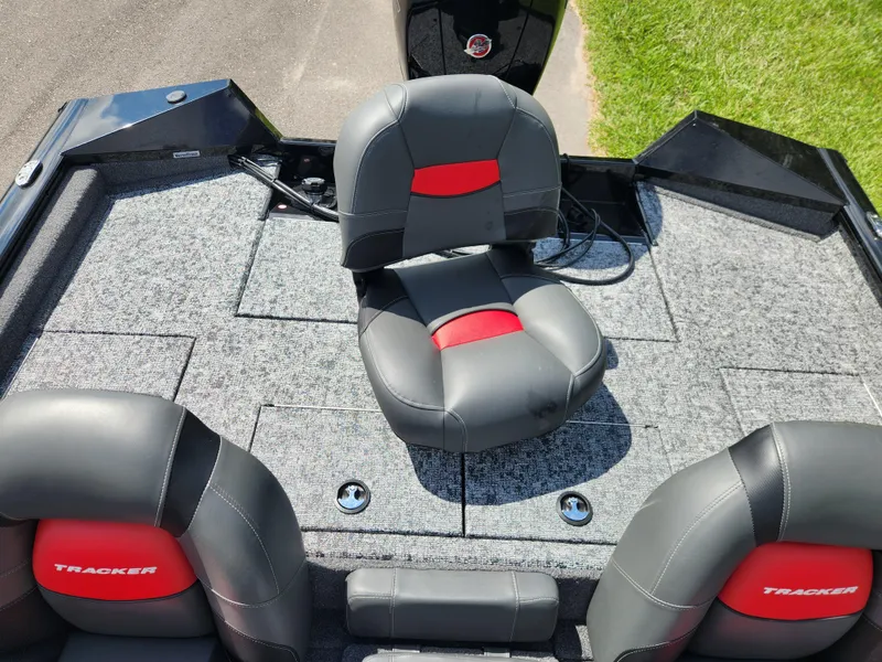 Slide: The Image of 2025 Tracker Pro Team 195 Tournament Edition boat interior with gray and red seating. - 13