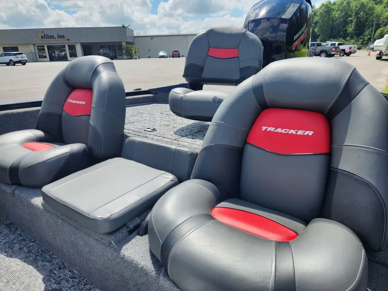 Slide: The Image of 2025 Tracker Pro Team 195 Tournament Edition boat seats, gray and red design, outdoor setting. - 14