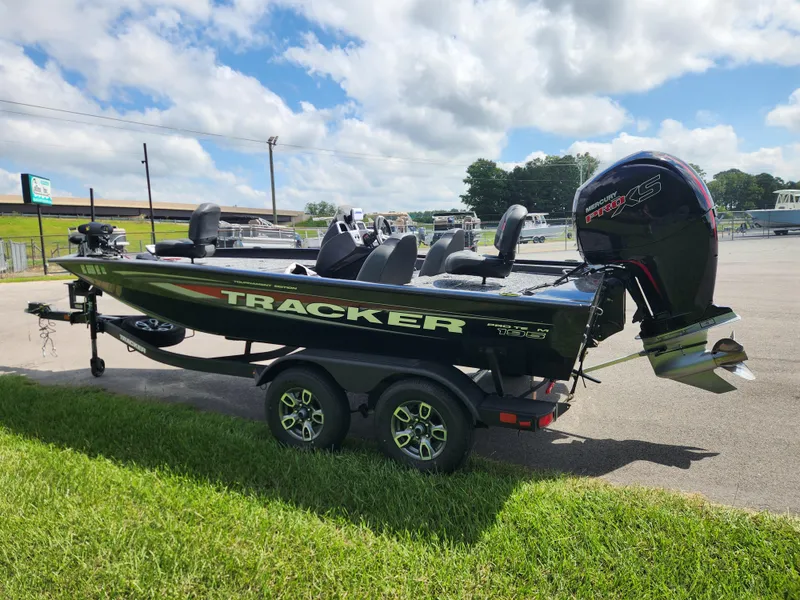 Slide: The Image of 2025 Tracker Pro Team 195 Tournament Edition boat on trailer, parked outdoors under cloudy sky. - 5
