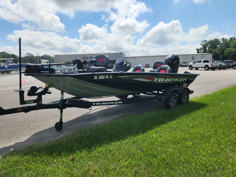 Slide: The Image of 2025 Tracker Pro Team 195 Tournament Edition boat on trailer, parked outdoors. - 7