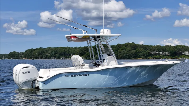 The Image of 2024 Key West 244 Center Console boat on water, featuring Yamaha engine, under blue sky. - 0