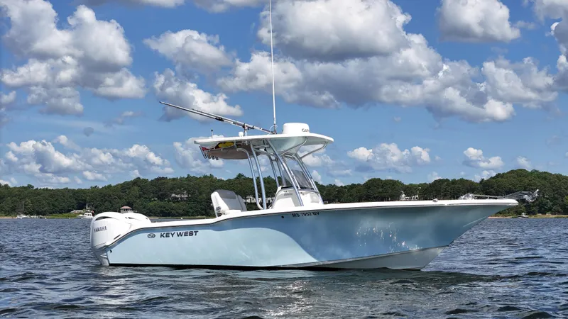 Slide: The Image of 2024 Key West 244 Center Console boat on water under a partly cloudy sky. - 1