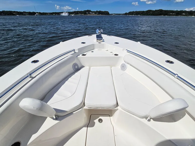 Slide: The Image of 2024 Key West 244 Center Console boat interior with white seating on a calm water backdrop. - 11