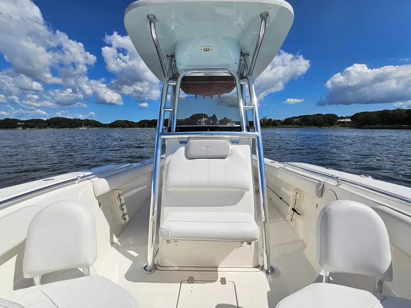 Slide: The Image of 2024 Key West 244 Center Console boat on a sunny day, with blue sky and clouds. - 12
