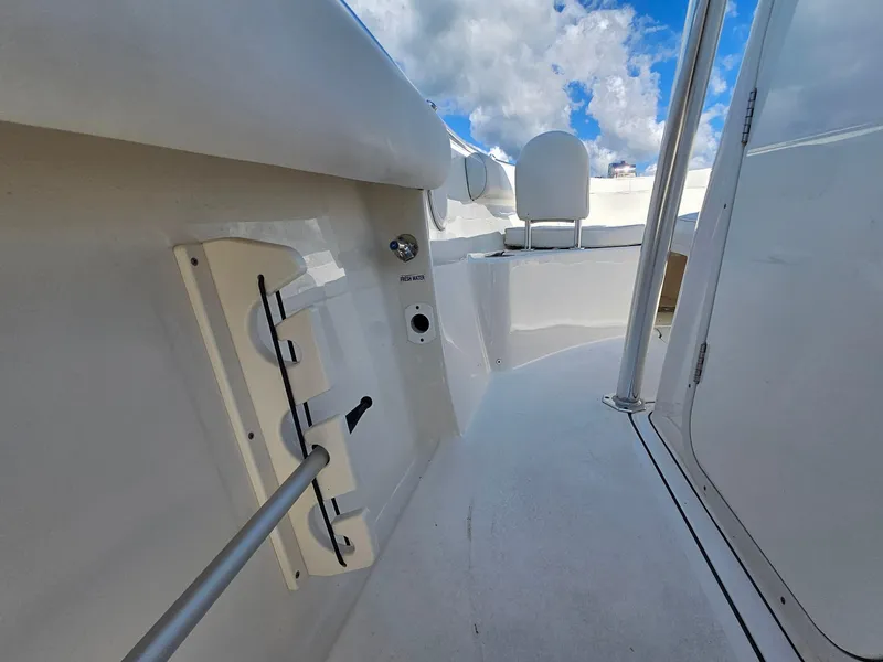 Slide: The Image of 2024 Key West 244 Center Console boat interior with rod holder and fresh water access. - 17