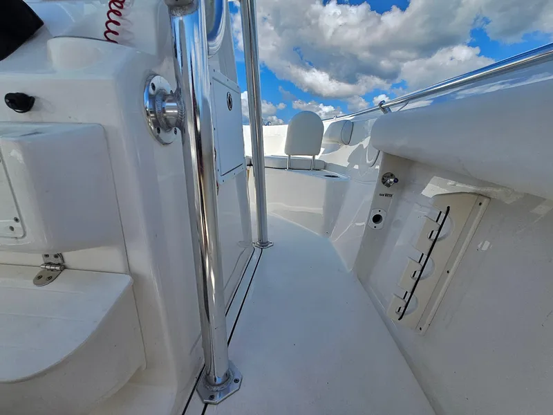 Slide: The Image of 2024 Key West 244 Center Console boat interior with stainless steel features and clear blue sky. - 18