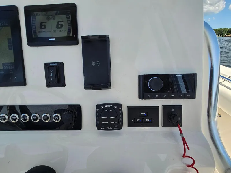 Slide: The Image of Control panel of 2024 Key West 244 Center Console boat with various instruments and switches. - 23