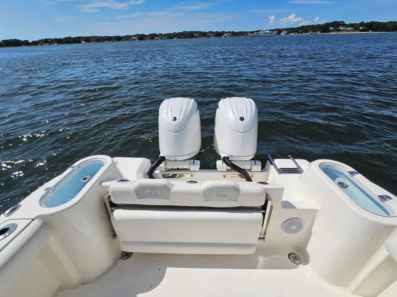 Slide: The Image of 2024 Key West 244 Center Console boat with dual engines on a calm lake. - 25