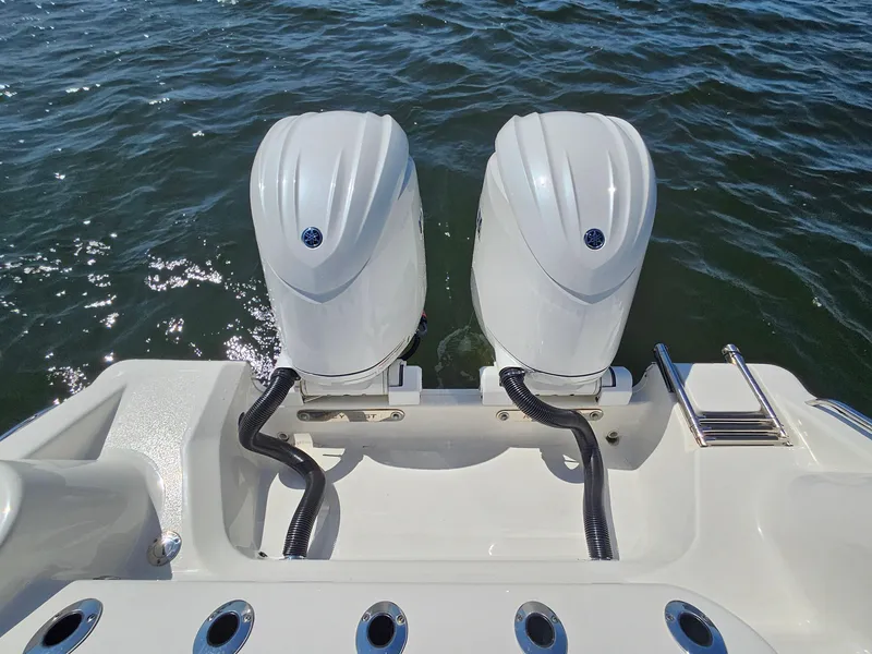 Slide: The Image of 2024 Key West 244 Center Console boat with dual outboard motors on water. - 27