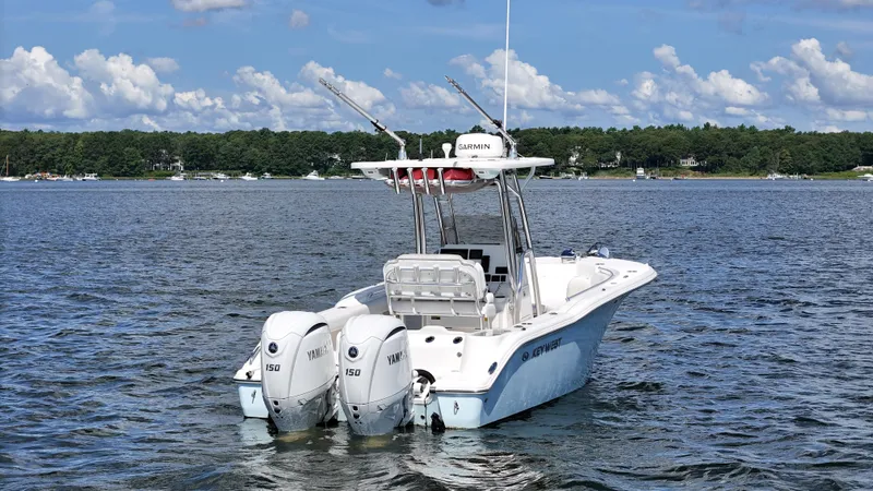 Slide: The Image of 2024 Key West 244 Center Console boat with twin Yamaha engines on a lake. - 4