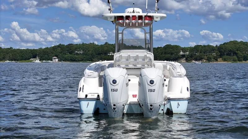 Slide: The Image of 2024 Key West 244 Center Console boat with twin 150 engines on a scenic lake. - 5