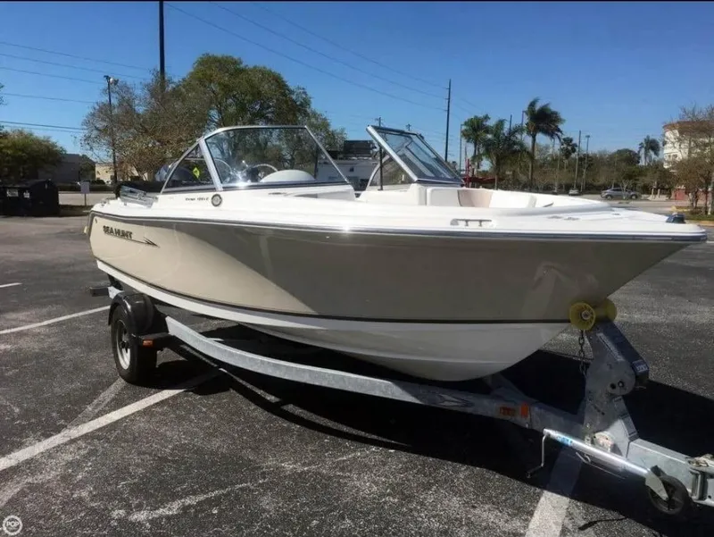 Slide: The Image of 2013 Sea Hunt Escape 188 boat on trailer in sunny parking lot. - 0