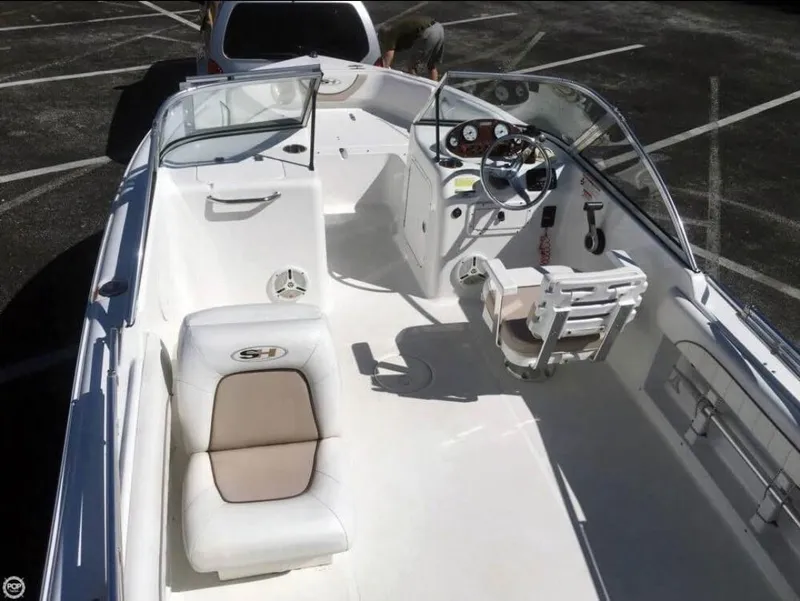 Slide: The Image of 2013 Sea Hunt Escape 188 boat interior with seating and steering wheel. - 5