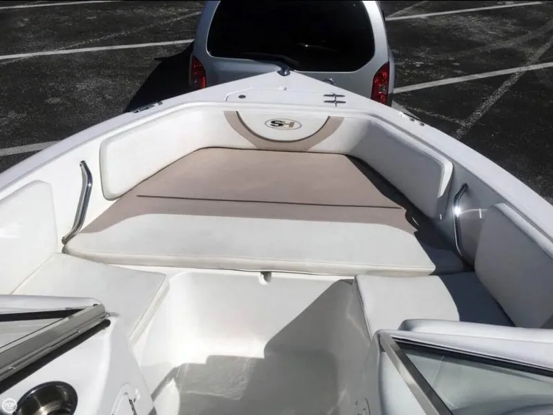 Slide: The Image of 2013 Sea Hunt Escape 188 boat interior with cushioned seating and sleek design. - 7