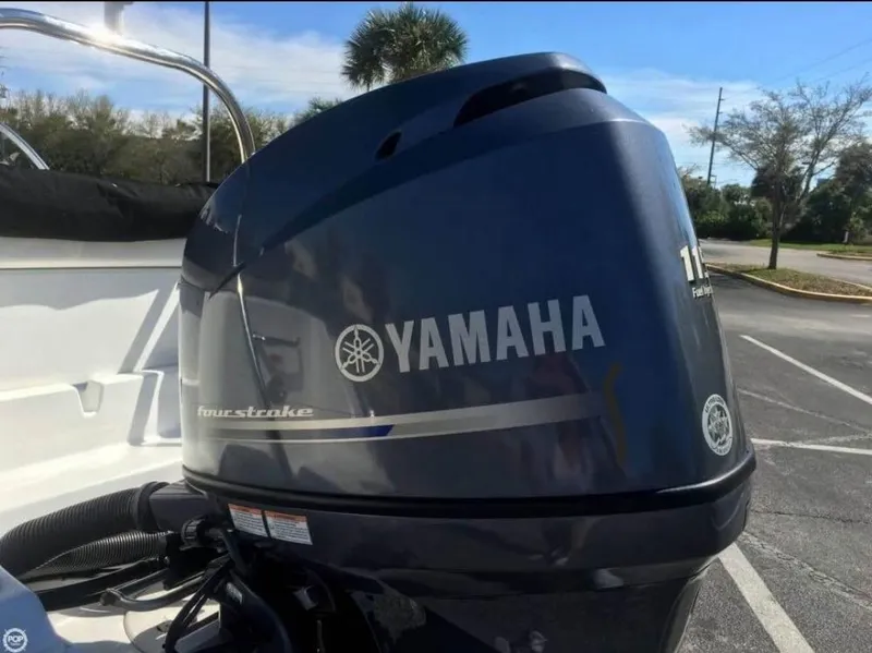 Slide: The Image of Yamaha four-stroke engine on 2013 Sea Hunt Escape 188 boat, parked outdoors. - 8