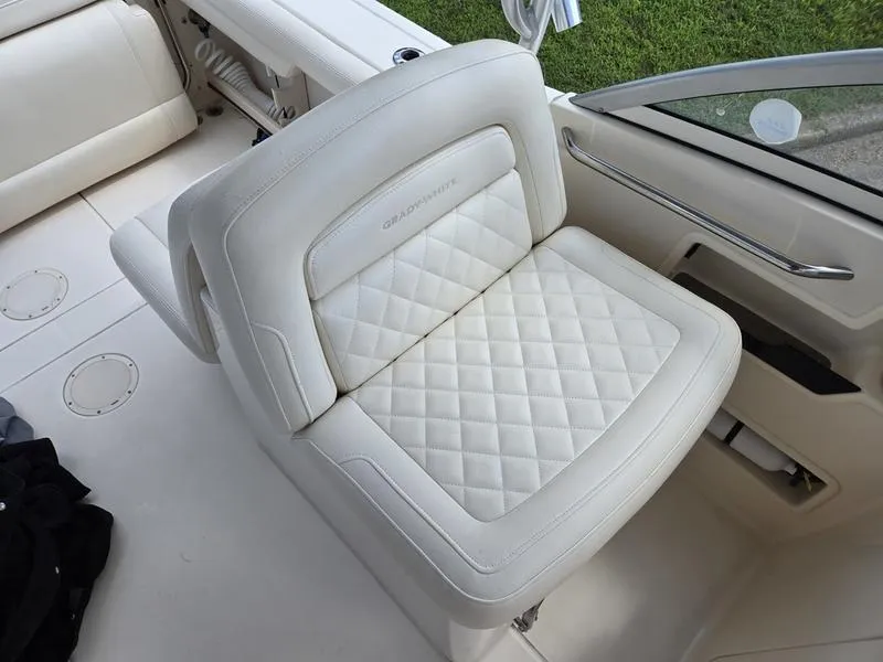 Slide: The Image of 2019 Grady-White Freedom 235 boat seat with quilted white upholstery. - 12