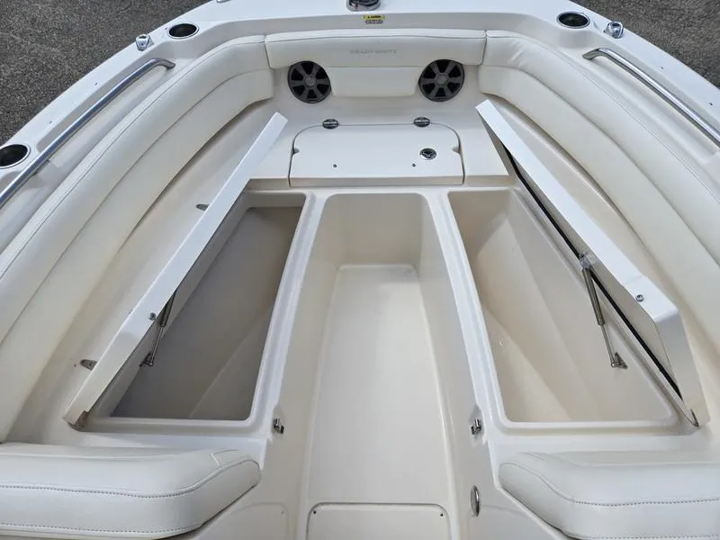 Slide: The Image of 2019 Grady-White Freedom 235 boat interior with open storage compartments and seating. - 13