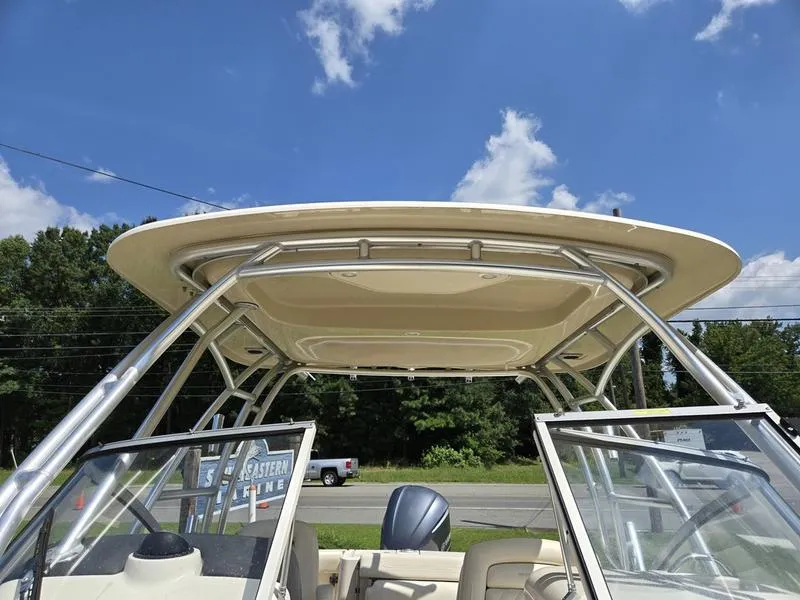 Slide: The Image of 2019 Grady-White Freedom 235 boat with T-top under a clear blue sky. - 16