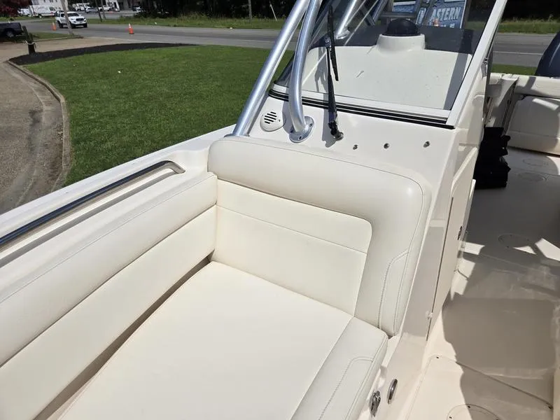Slide: The Image of 2019 Grady-White Freedom 235 boat interior with cream seating and stainless steel railings. - 18