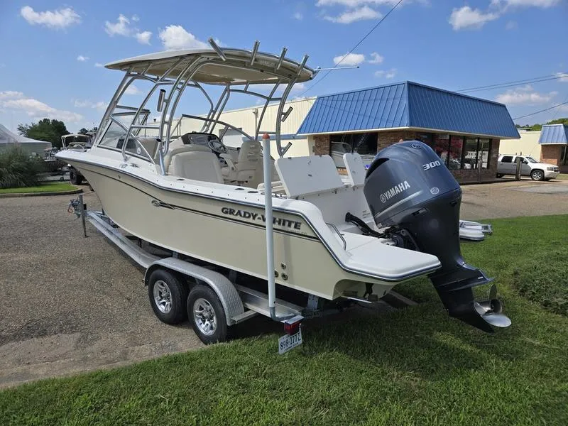 Slide: The Image of 2019 Grady-White Freedom 235 boat on trailer with Yamaha 300 engine, parked outdoors. - 3