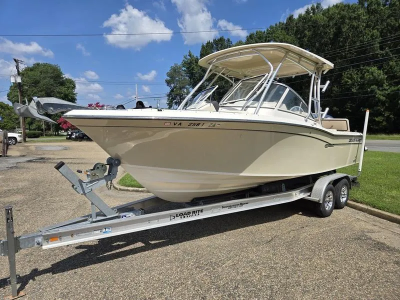 Slide: The Image of 2019 Grady-White Freedom 235 boat on trailer, parked outdoors under blue sky. - 4