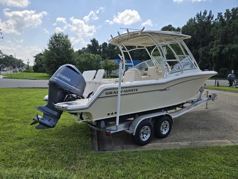 Slide: The Image of 2019 Grady-White Freedom 235 boat on trailer with Yamaha engine, parked on grass. - 6