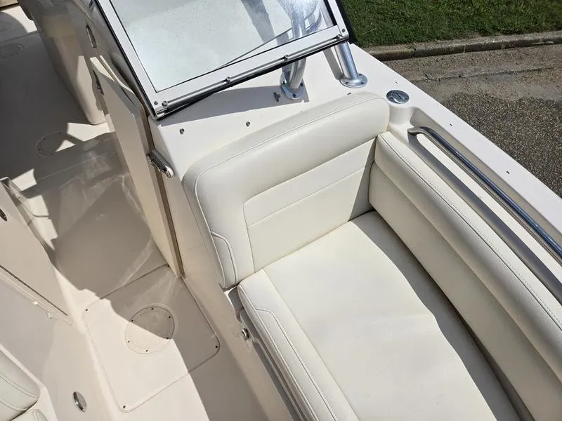 Slide: The Image of 2019 Grady-White Freedom 235 boat interior with white seating and windshield. - 8