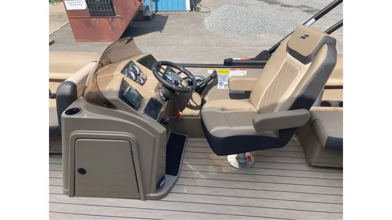 Slide: The Image of 2026 Starcraft EXS 1 boat helm with beige captain's chair and dashboard controls. - 4