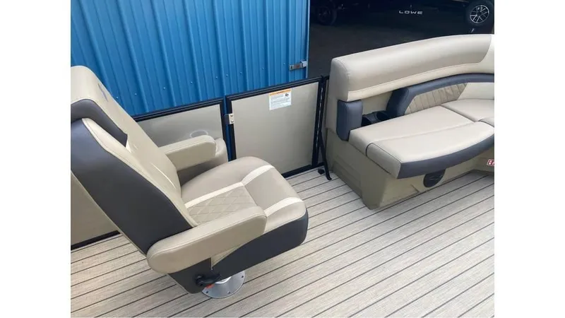Slide: The Image of 2026 Starcraft EXS 1 boat interior with beige and gray seating, blue panel background. - 7
