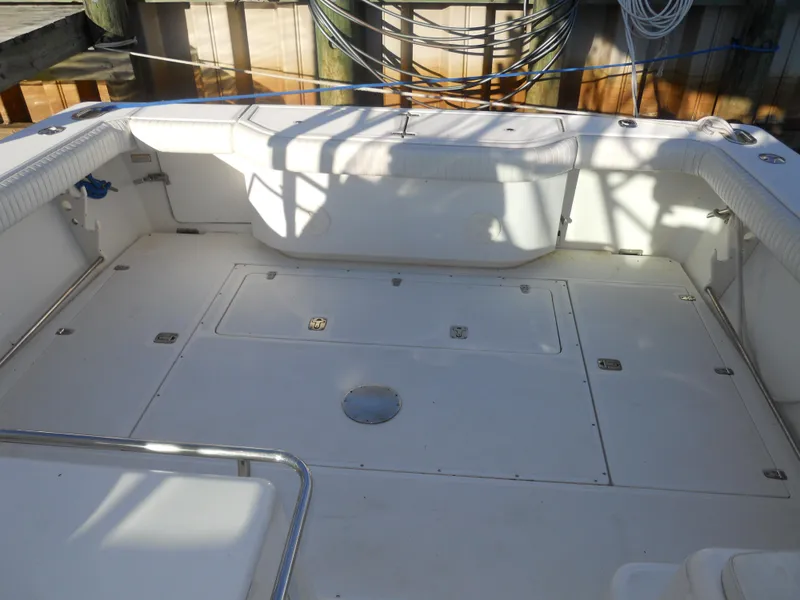 Slide: The Image of Spacious deck of 2000 Boston Whaler 34 Defiance boat, featuring clean white seating and storage. - 10