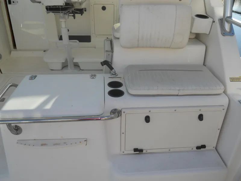 Slide: The Image of Boston Whaler 34 Defiance 2000 interior with seating, storage, and cup holders. - 13