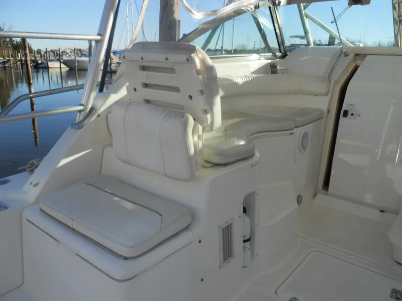 Slide: The Image of Interior of 2000 Boston Whaler 34 Defiance boat with white seating and helm area. - 14